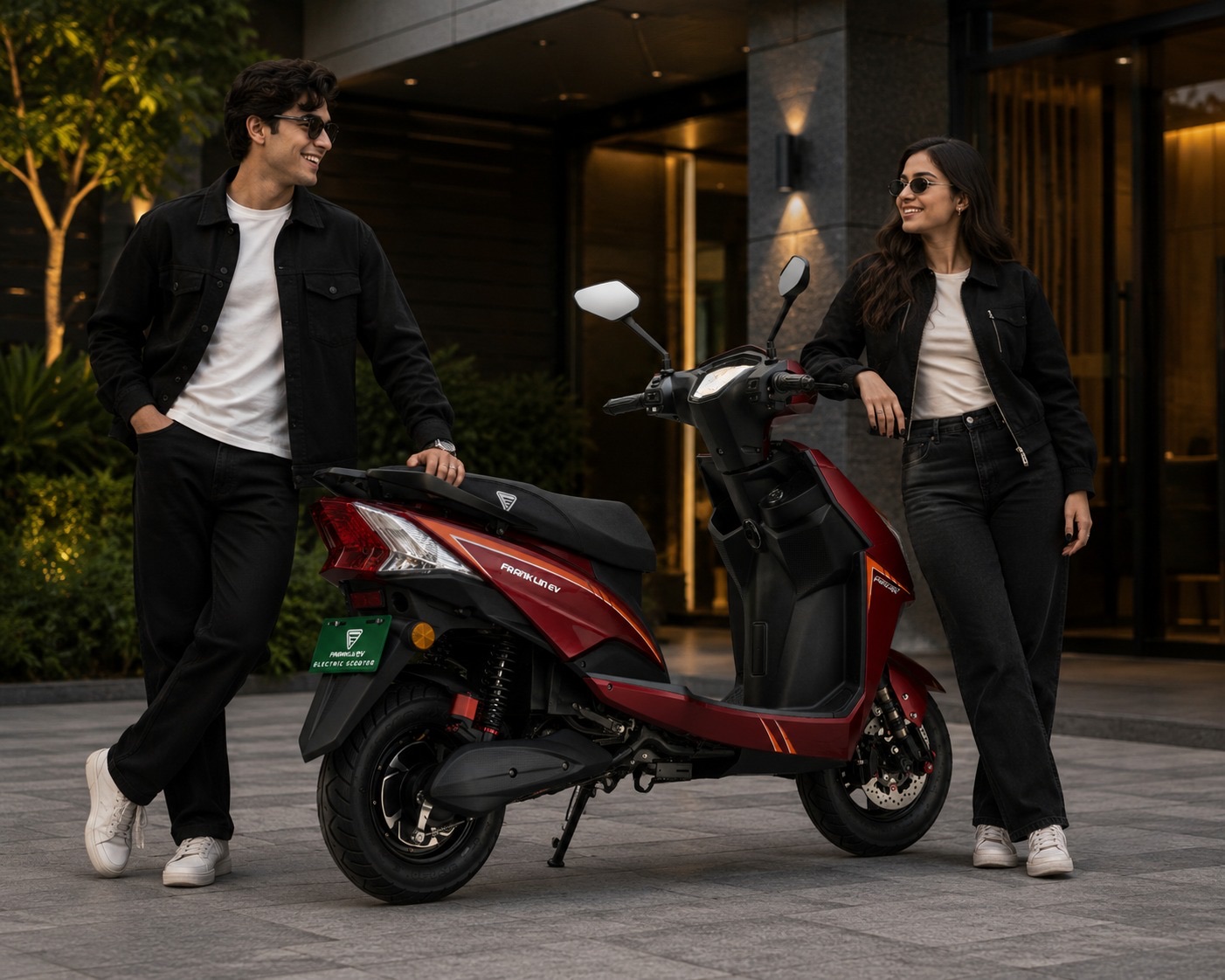 Two riders standing beside a Franklin EV scooter before a test ride.